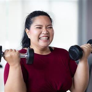 A woman lifting dumbbells for exercise.