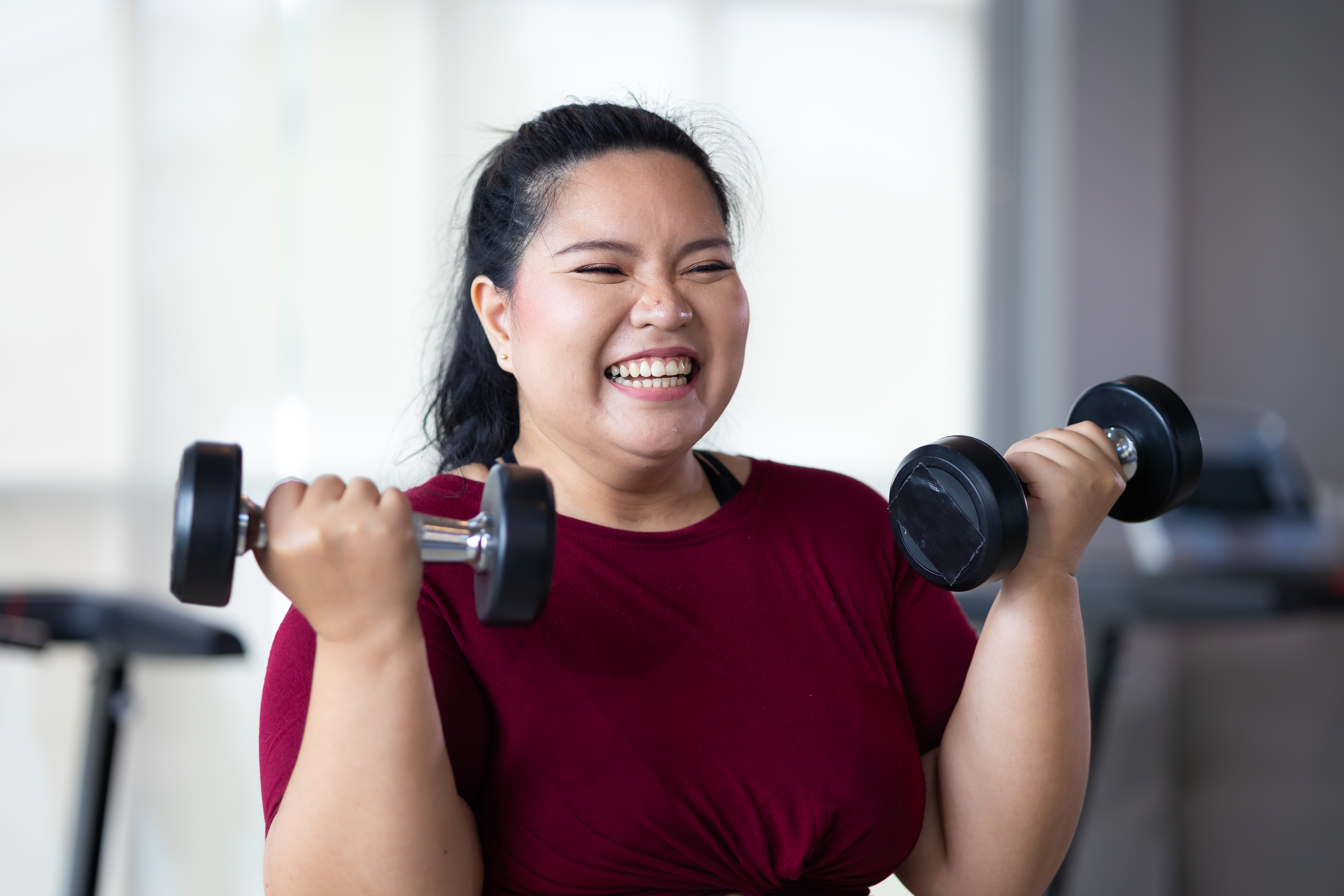 A woman lifting dumbbells for exercise.